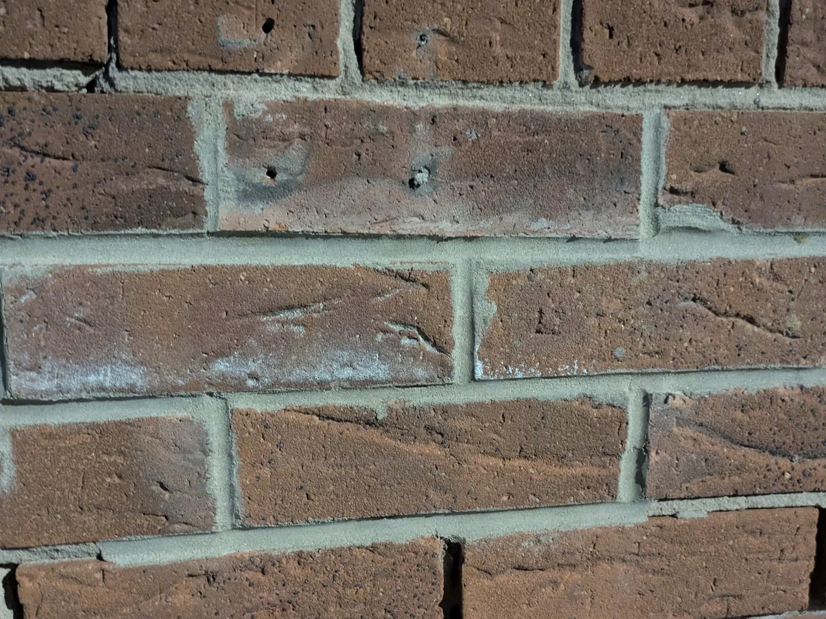 Close-up of a brick wall with freshly repointed mortar joints