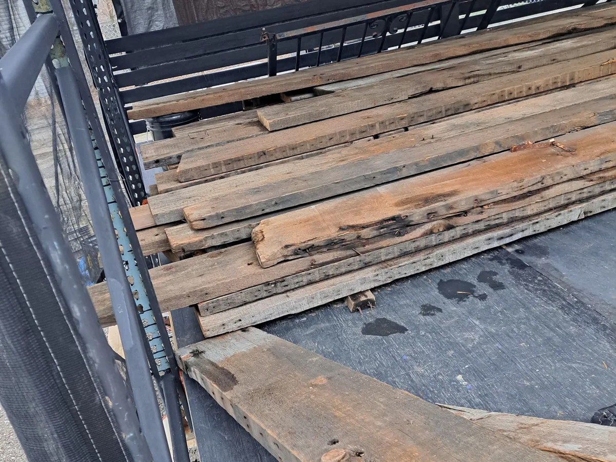 Dump trailer loaded with old lumber stripped out of a demolition job