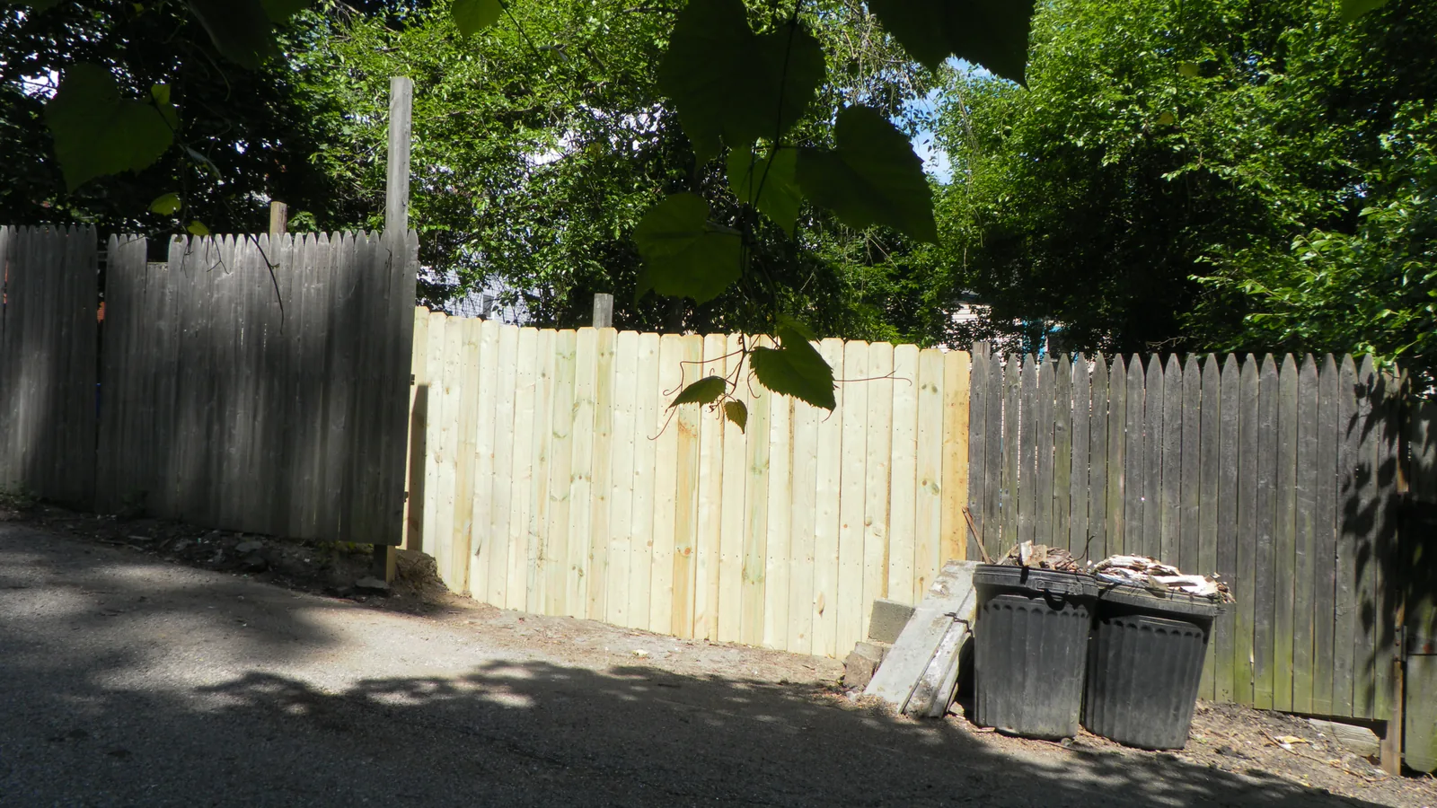 Back alley cleared and fenced after an outbuilding was taken down