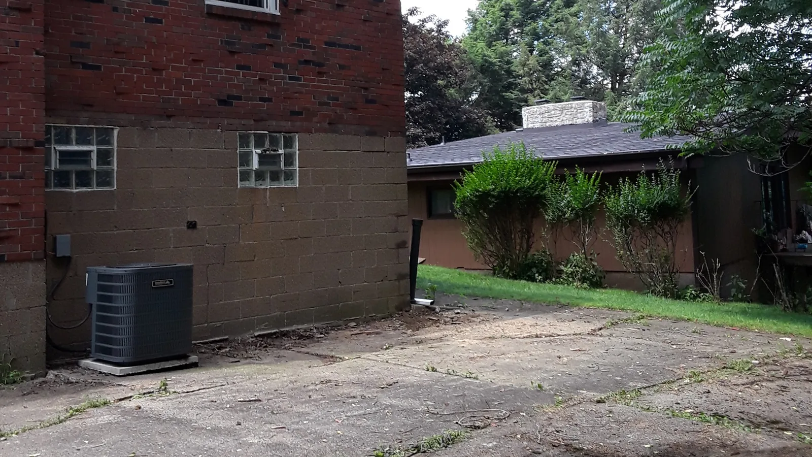 Clean concrete pad and open yard left after a deck was removed