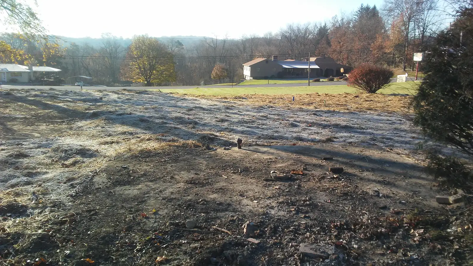 Demolition site after teardown with the lot fully cleared and graded flat